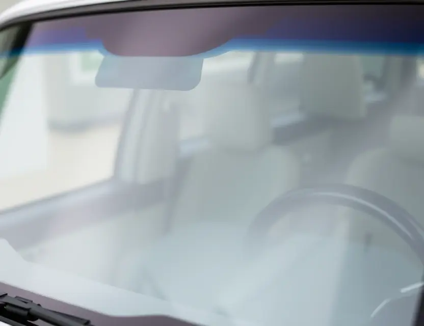 A close-up shot of a LEVC vehicle with a replaced windshield, showcasing the new glass and the repair process. Focus on the clarity and quality of the replacement windshield.