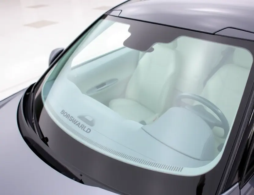 A close-up shot of a Borgward BX5 with a replaced windshield. The old windshield is visible next to the new one, showcasing the seamless integration. The car is parked on a clean, well-lit surface. Focus on the clarity and quality of the new windshield.